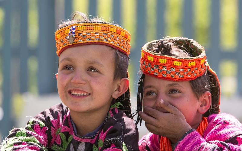 Two little Kalash girls sharing happiness