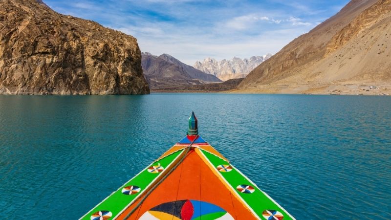 Colorful boat in Attabad lake in Hunza valley, Karakoram mountains range in Pakistan