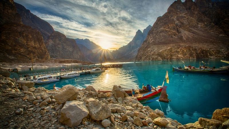 beautiful view of Attabad lake in Hunza valley, Karakoram mountains range in Pakistan, Boats and sunset in valley