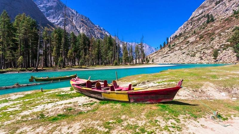 mountain, boat, clean lake and beautiful blue sky in Kalam, Swat Valley Pakistan.